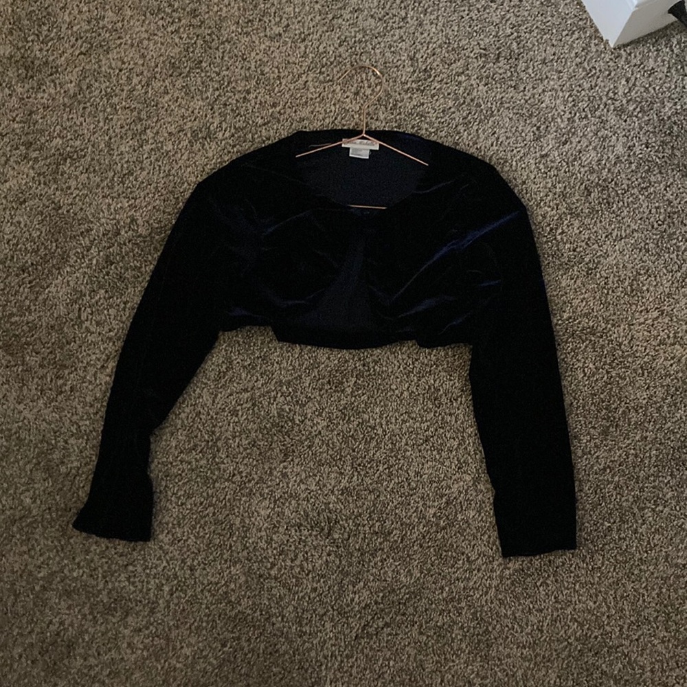 A sweater with a button, Navy blue and the brand is Jana Michelle